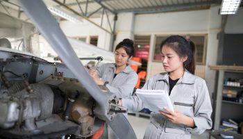 Asian women Engineers and technicians are repairing aircraft.