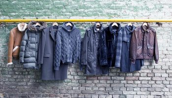 Men's trendy clothing on grunge brick wall. Concept background